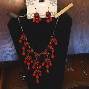 26” Gold plated necklace with red and black beads.